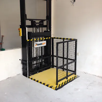 Hydraulic freight lift with Powerlift nameplate on the inner mesh gate
